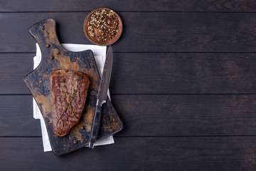 Grilled beef steak on wooden table
