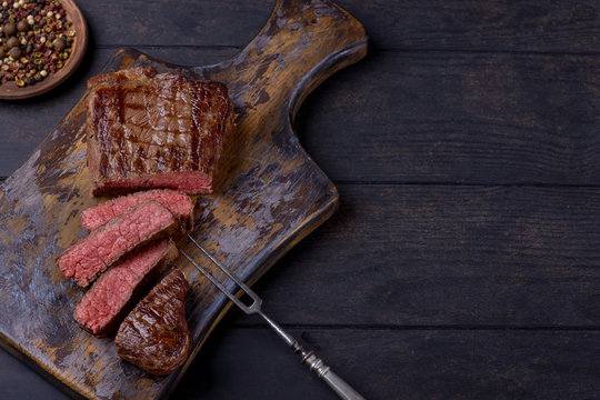 Top view sliced steak on cutting board
