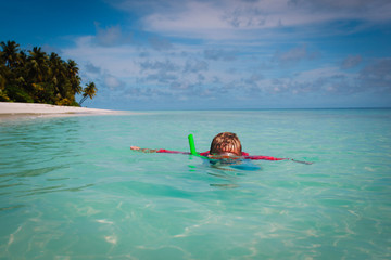 little boy swimming with mask at sea