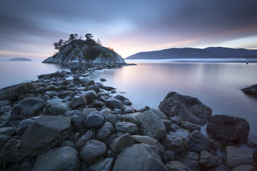 Fog and mist roll into Whytecliff Park at sunset producing some vivid colors in West Vancouver BC Canada.