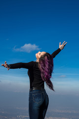 Young beautiful woman posing on cliff