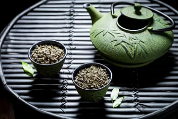 Foto op Aluminium Healthy green tea in Asian restaurant on black bamboo table © shaiith