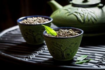 Closeup of healthy green tea on black bamboo table