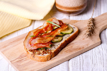 Bread with fried smoked bacon and fried zucchini