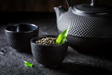 Papier Peint photo Lavable Theé Closeup of green tea with teapot and cup