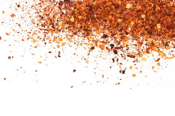 pile crushed red cayenne pepper, dried chili flakes and seeds isolated on white background, top view