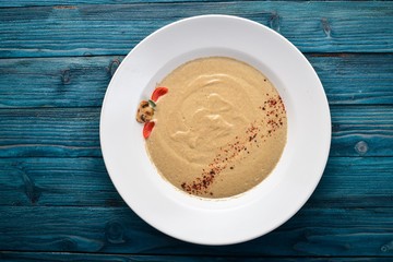 Mushroom puree soup. On a wooden background. Free space for your text. Top view.