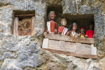 famous burial site with coffins placed in caves carved into the rock, guarded by the statues of the...
