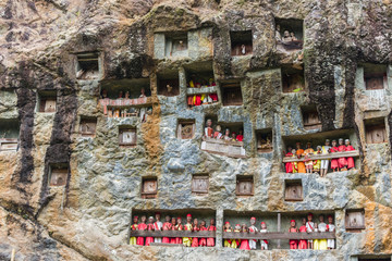 famous burial site with coffins placed in caves carved into the rock, guarded by the statues of the...