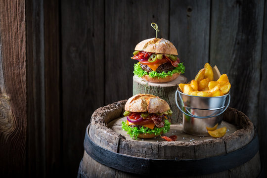 Burger with vegetables, beef and pepperoni served with chips