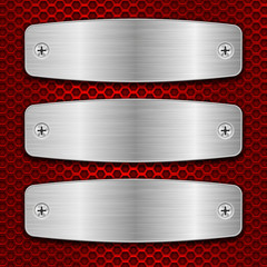 Metal brushed plates with screws on red perforated background