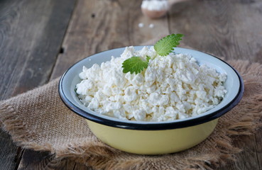 Fresh cottage cheese in an iron bowl