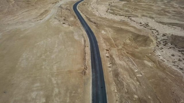 Desert road - Aerial footage of a new two lane road surrounded by dry desert landscape