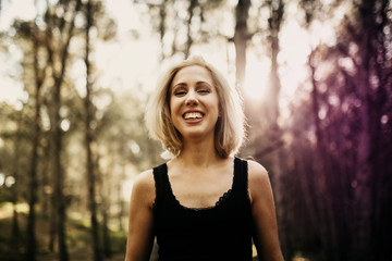Happy blonde woman looking at camera while enjoy nature.