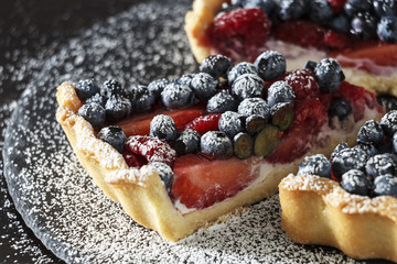 Fresh strawberry, blueberry and raspberry with ricotta tart cake. Selective focus.