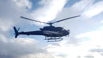 blue helicopter flying in the sky