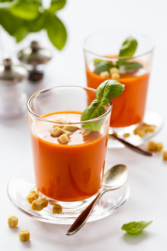 Glass with delicious homemade cream tomato soup with croutons. Healthy food concept.
