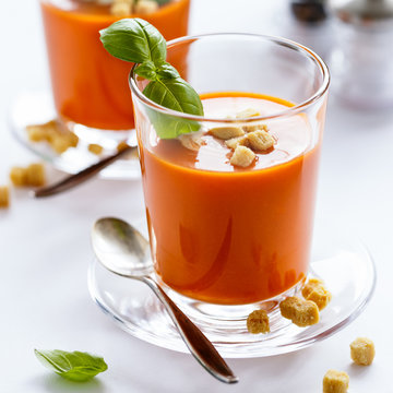 Glass with delicious homemade cream tomato soup with croutons. Healthy food concept.