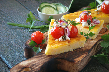 Corn polenta with Parmesan, roasted tomatoes, goat cheese