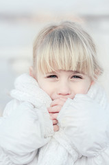 Close up of the attractive blonde girl snoring on the street on cold frosty day and trying to get...