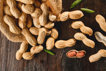 Fototapeta premium Composition of peanuts serving to make oil, peanut butter. Great for healthy and dietary nutrition. Concept of: condiments, dried fruit, food.