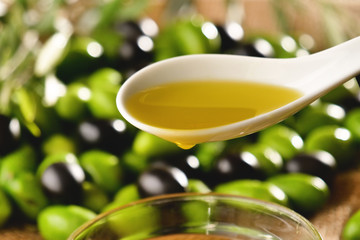Genuine Italian organic oil cold pressed in slow motion falls on organic bread. concept of nature and healthy food, healthy and natural. fresh olives and Tuscan Italian oil