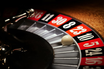Macro shot of a roulette in a casino where the ball goes to the green or red or black number....