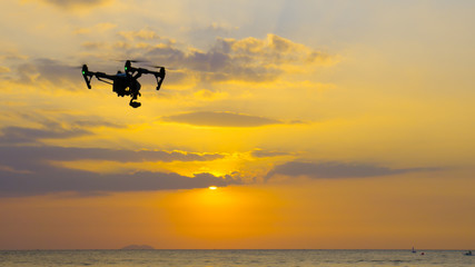 Professional camera drone flying on sea.