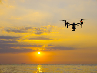 Professional camera drone flying on sea.
