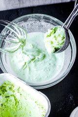 organic ice cream homemade process on dark background with hands