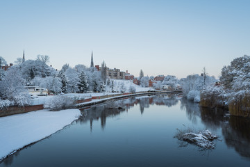 Winter view along the River Severn from the English Bridge in Shrewsbury, Shropshire, a festive...