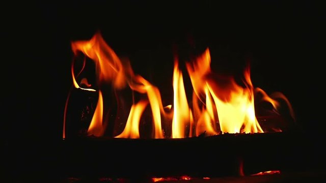 Beautiful warm burning logs in indor fireplace filmed in super slow motion.