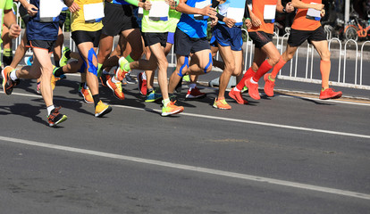 marathon runners legs running on city road