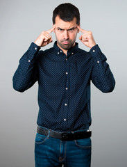 Handsome man thinking on grey background