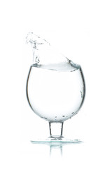 A glass of water, a splash of water
