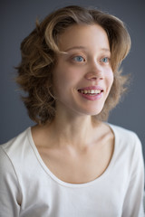 Fototapeta premium Portrait of young pretty smiling woman amazedly looking aside isolated