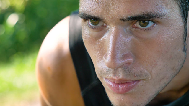 Portrait of a handsome young guy sportsman, holding a phone, smiling, wearing sports clothes, running outside. Concept: love sports, healthy lifestyle, be beautiful, muscles, happy, burn calories. - Powered by Adobe