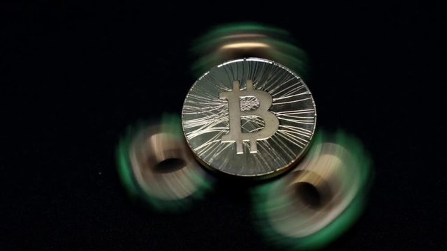 Rotating toy spiner and gold coin bitcoin.