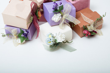 Pastel colours  carton wedding gift boxes with ribbon and flowers with text space