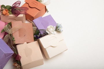 Light colours gift boxes  with flowes and ribbons, on white background copy spaces for text