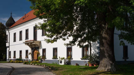 Fototapeta na wymiar Historic building with flowers in the windows