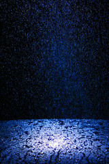 Dark background shot of rain falling