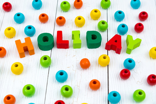 Holiday colorful wooden text on white wooden desk with Christmas decorations, Merry Christmas and happy new year concept.