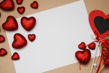 Love and Valentine's Day. Greeting Card with Red Shinny Glitter Hearts and White Blank for Text, Brown Neutral background