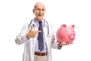 Elderly doctor holding a piggybank and pointing