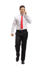 Elegant man walking and talking on a phone
