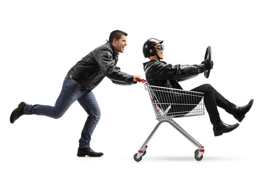 Biker pushing a shopping cart with another biker holding a steering wheel