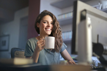 Happy woman sitting at her desk