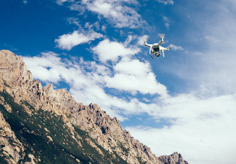 Obraz na płótnie Canvas drone flying in the air over high altitude mountains
