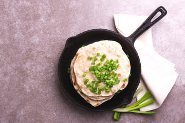 Indian flatbread chapati, green onion. Color surge trend.